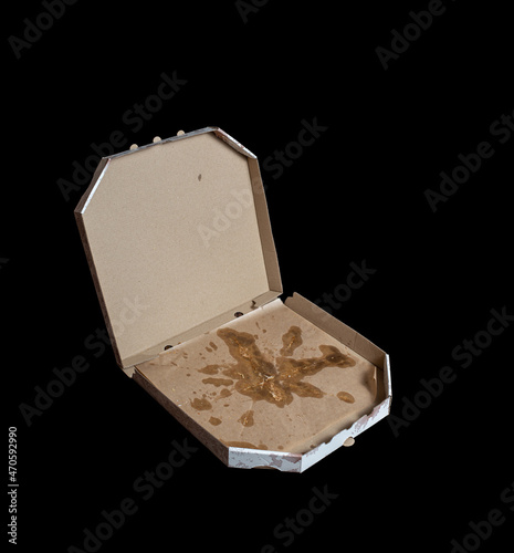 dirty pizza box isolated on black. empty cardboard pizza box. greasy stains. unhealthy food concept