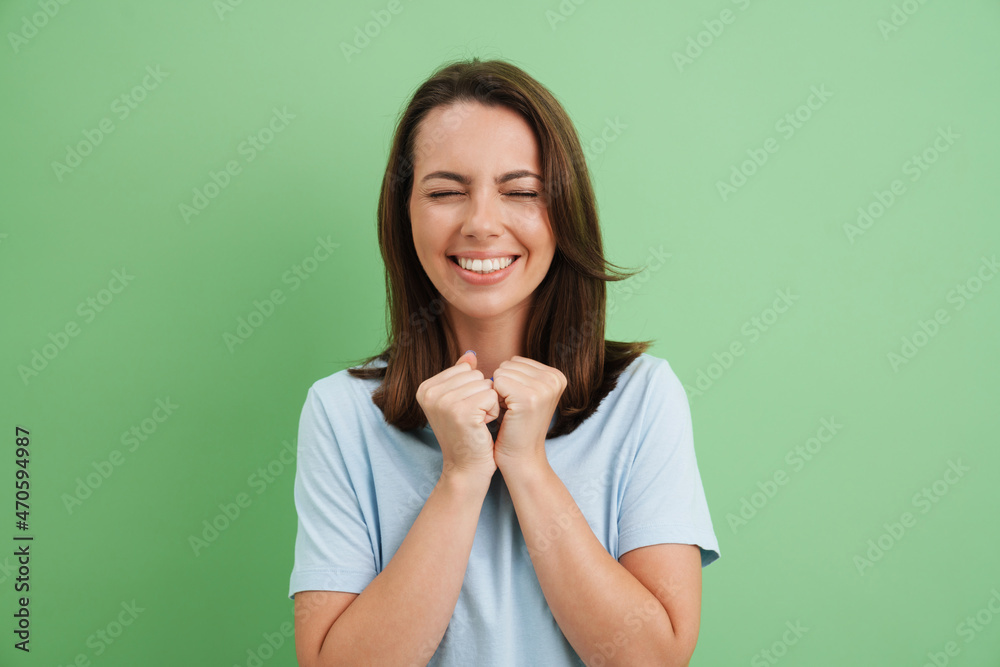 Young european woman laughing with clenched fists Young european woman laughing with clenched fists