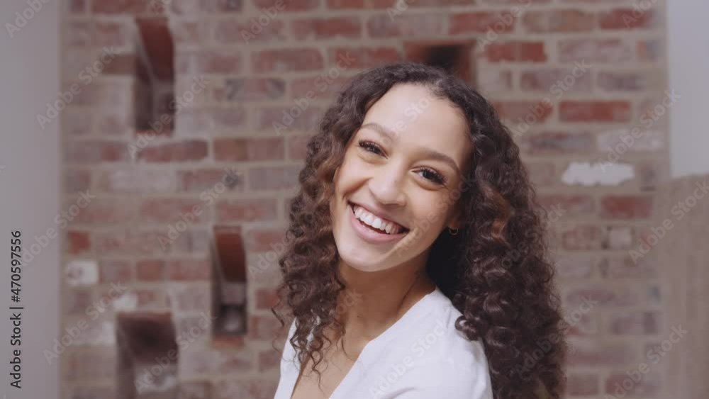 Young beautiful African American female smiling in mirror after completing bed time skin care routine in the bathroom Young beautiful African American female smiling in mirror after completing bed time skin care routine in the bathroom