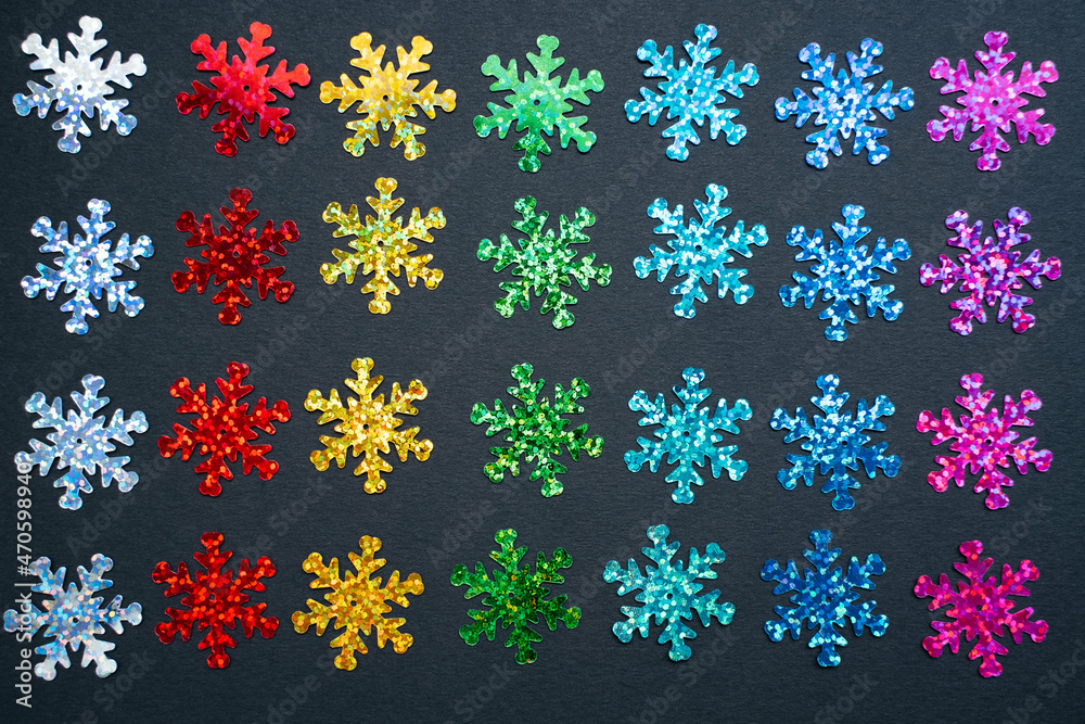 rainbow color snowflakes on black paper background