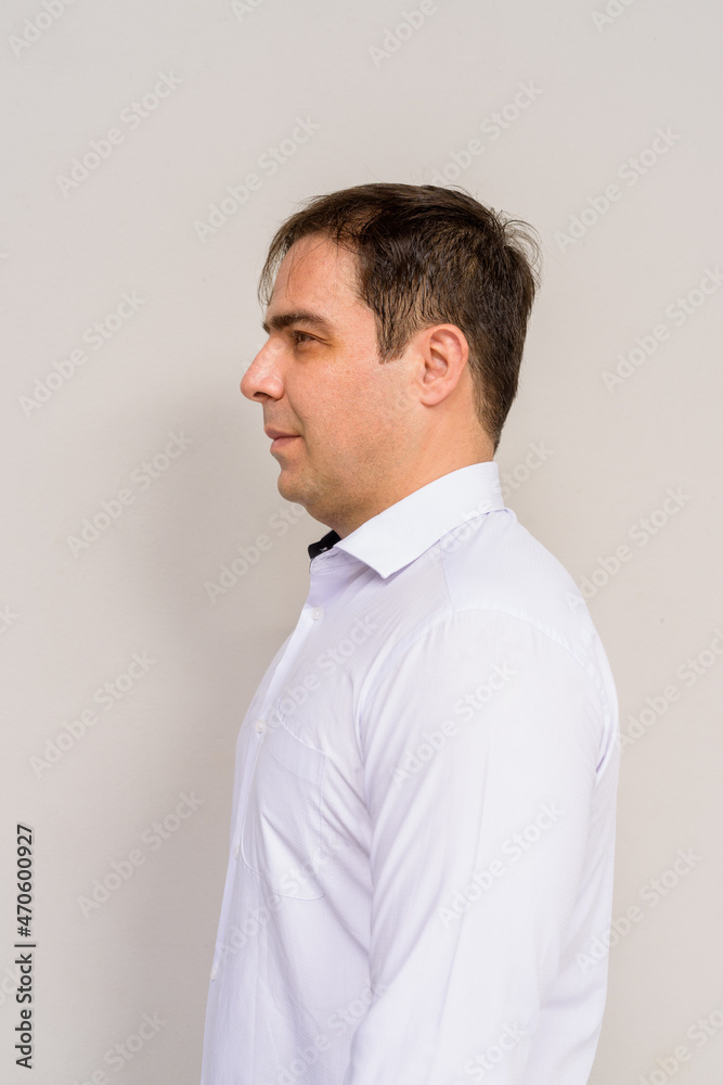 Side view portrait of handsome Persian man against plain background Side view portrait of handsome Persian man against plain background