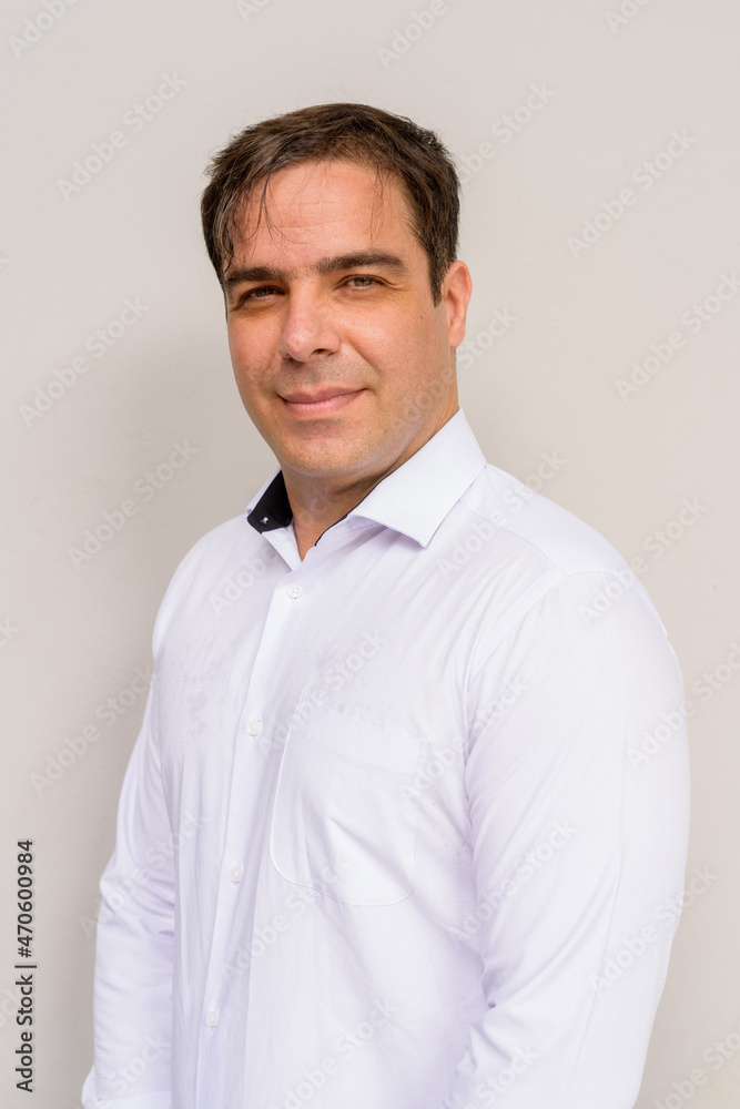Portrait of handsome Persian man against plain background Portrait of handsome Persian man against plain background