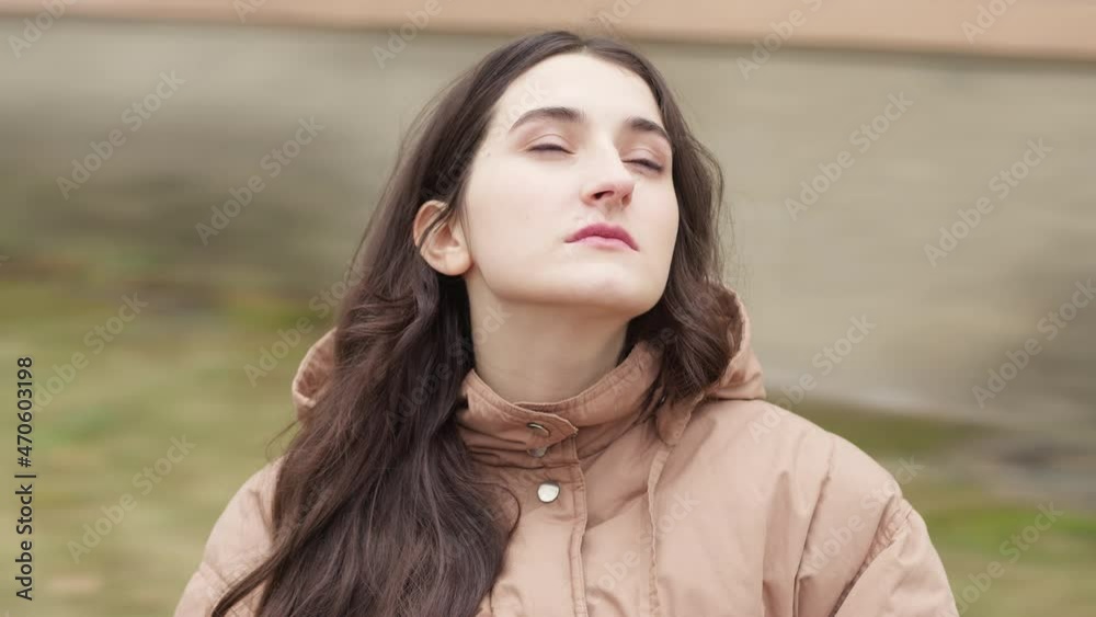 A pensive beautiful girl is dreaming about something. A young woman is sad on an autumn day, spinning with the camera in a circle. Slow motion. A pensive beautiful girl is dreaming about something. A young woman is sad on an autumn day, spinning with the camera in a circle. Slow motion.