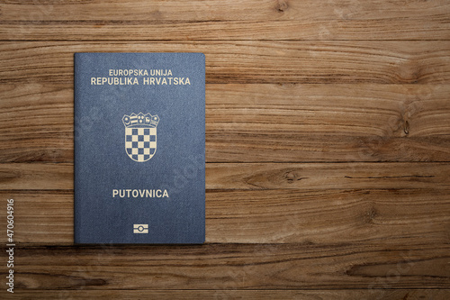 Croatian passport on wooden background citizenship by investment