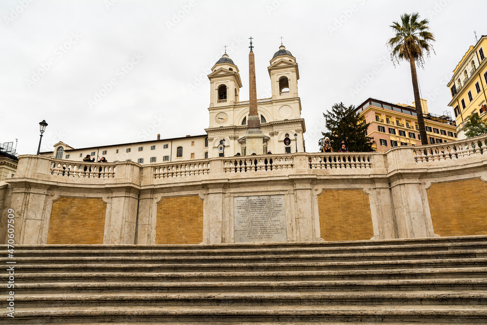 Trinita dei Monti church with Spanish Steps in foreground in a rainy day, Rome, Italy