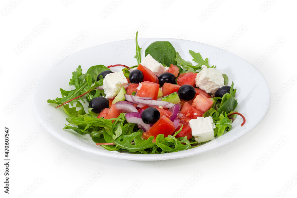 Greek salad on white dish on a white background
