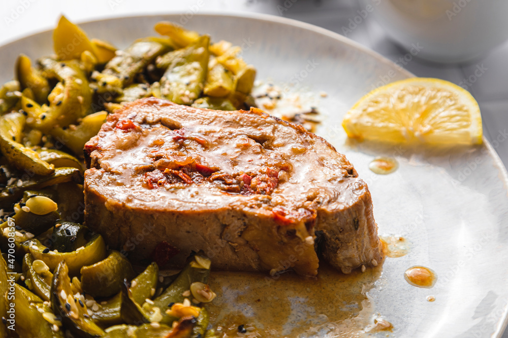 Roasted stuffed pork loin with lemon zucchini salad in plate Roasted stuffed pork loin with lemon zucchini salad in plate