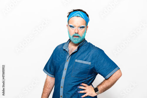Bearded drag queen with hand on hip against white background