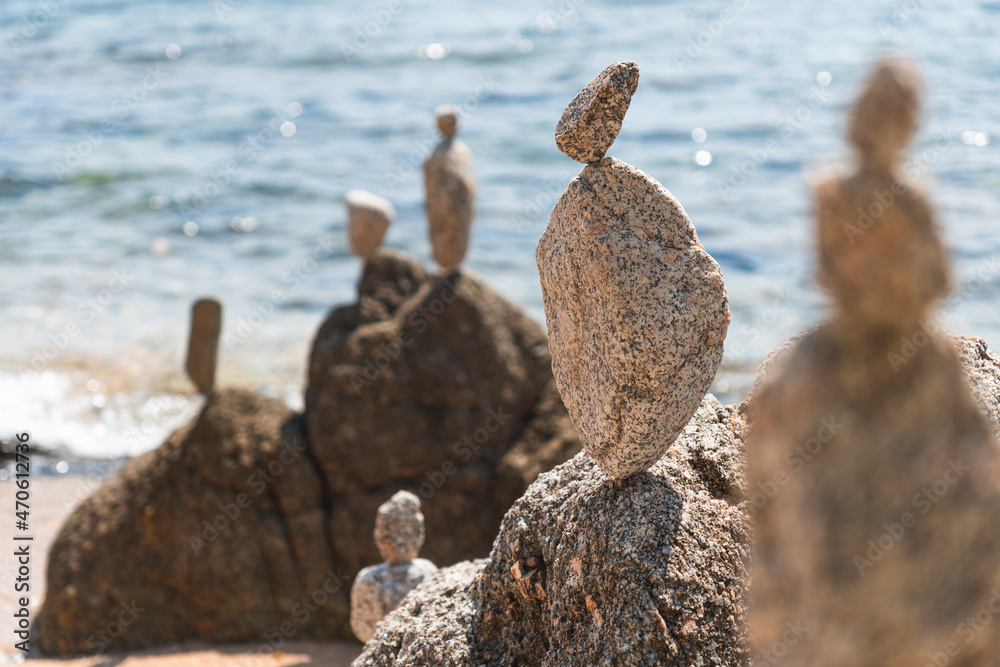 Rocks stacked at beach on sunny day, Lloret De Mar, Catalonia, Spain Rocks stacked at beach on sunny day, Lloret De Mar, Catalonia, Spain