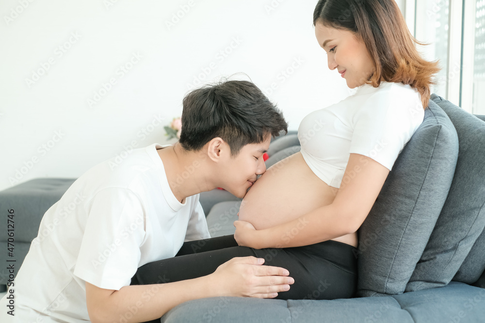 portrait asia young pregnant woman and husband happy together on sofa portrait asia young pregnant woman and husband happy together on sofa