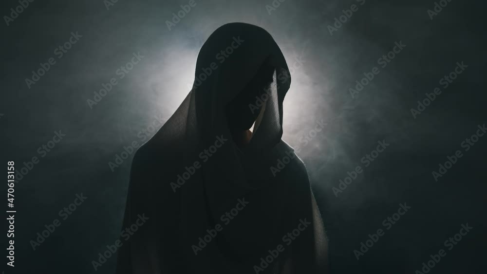 Man in mantle in the dark