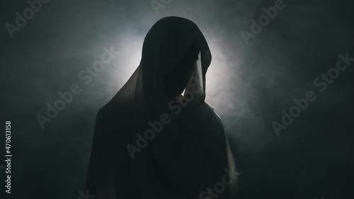 Man in mantle in the dark