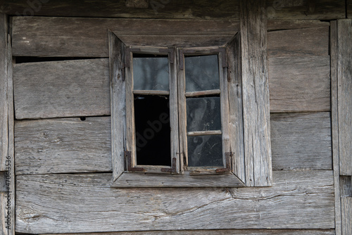 Sunja,Croatia,05,04,2021. Rustic style aged window in wooden village rural home wall.