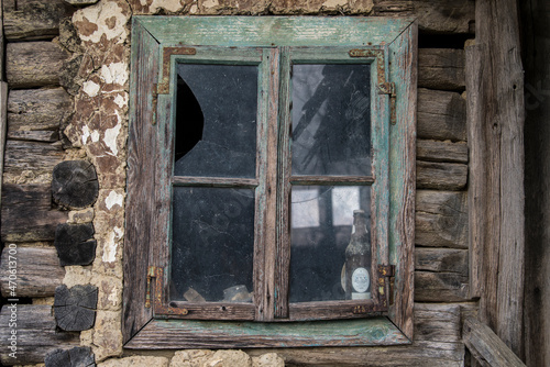 Sunja,Croatia,05,04,2021. Rustic style aged window in wooden village rural home wall.