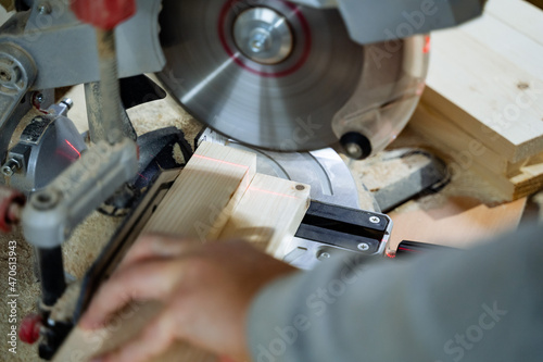 Craft. The process of wood processing. A close shot of the saw. Cutting a wooden bar. Installation for sawing boards. Equipment in the carpentry workshop