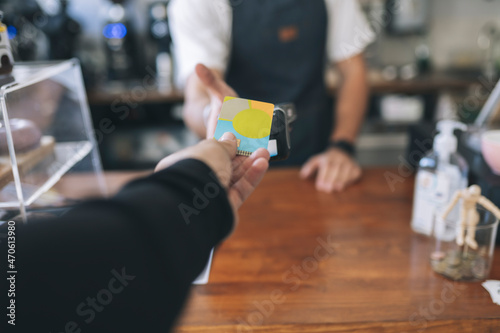 Customer paying through credit card in cafe