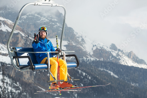 Skier man on ski chair lift