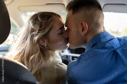 Romantic couple kissing each other in car photo