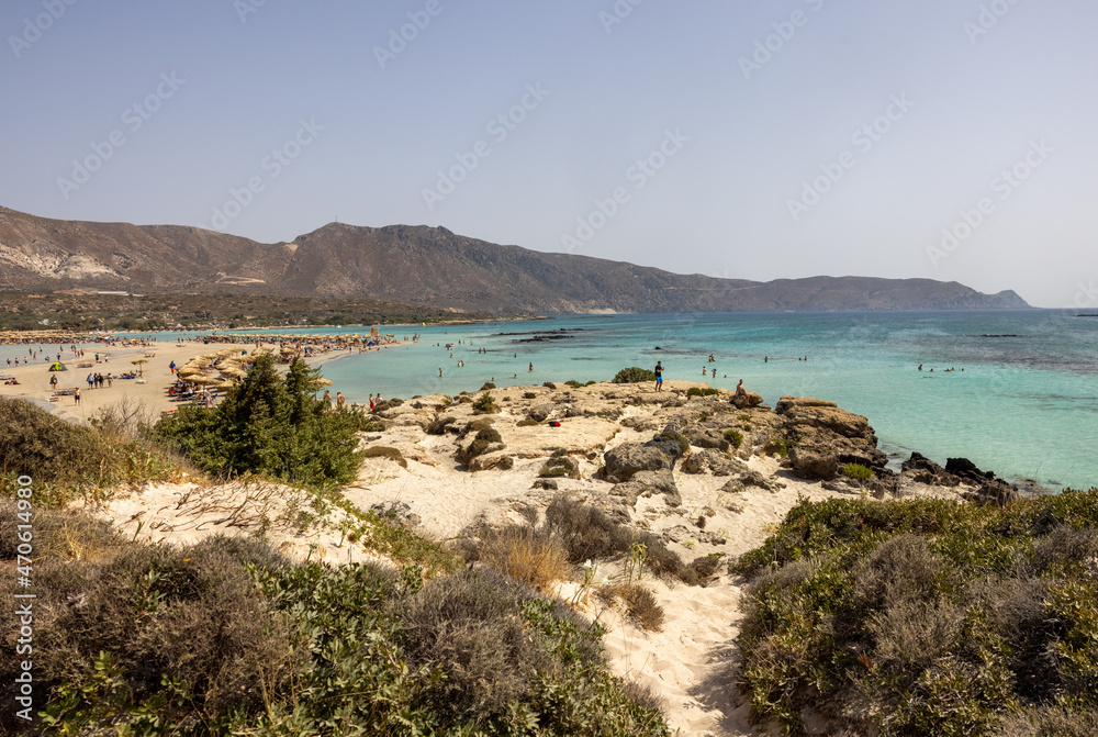 People relaxing on the famous pink coral beach of Elafonisi on Crete, Mediterannean sea, Greece