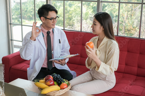 Professional nutritionist asia man consulting asia woman in clinic or hospital or medical club