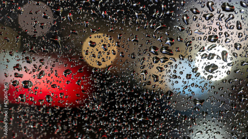 Canvas Print colorful diffuse unsharp lights behind glass window with rain drops