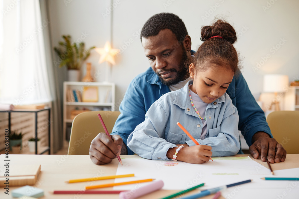 Portrait of African-American man with little girl drawing together at home, copy space Portrait of African-American man with little girl drawing together at home, copy space