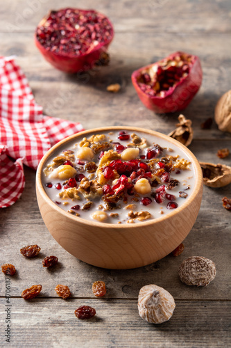 Traditional Turkish Noah's pudding in bowl on wooden table	 photo