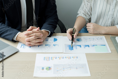 Two business leaders talk about charts, financial graphs showing results are analyzing and calculating planning strategies, business success building processes