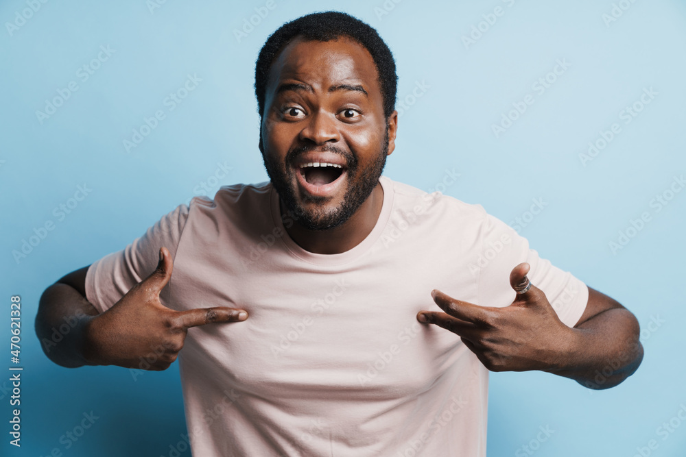 Black bristle man laughing and pointing fingers at himself Black bristle man laughing and pointing fingers at himself