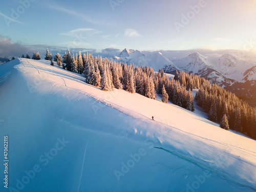 Woman skiing on snow covered mountain at sunrise, Schonkahler, Tyrol, Austria photo