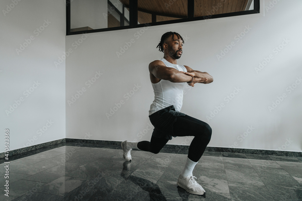 Young man exercising with arms crossed