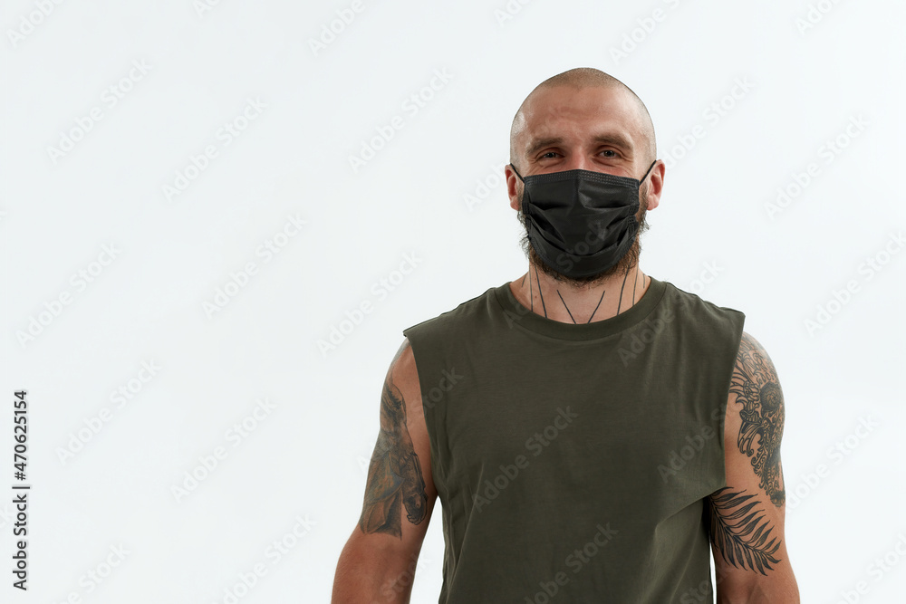 Young caucasian man in medical mask look at camera Young caucasian man in medical mask look at camera
