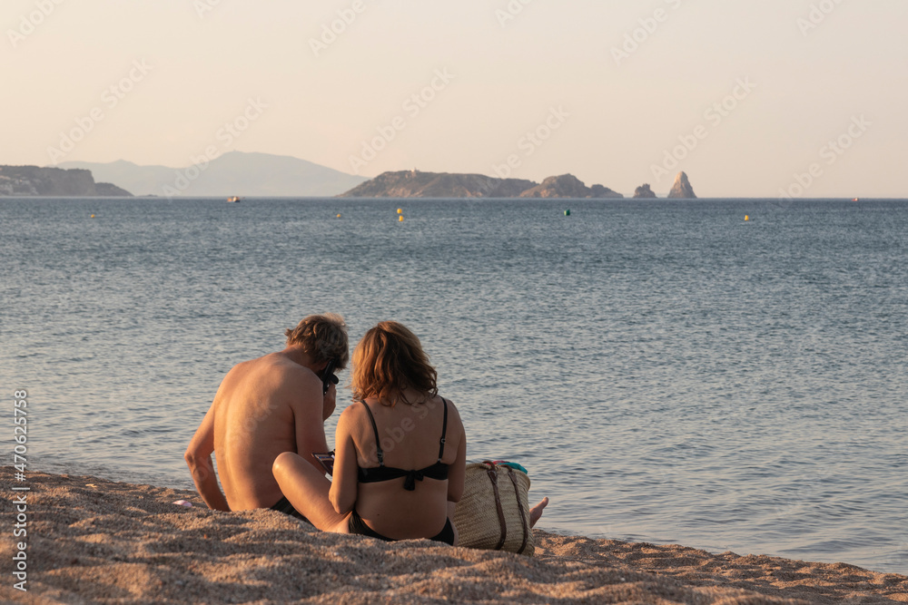 couple embracing on the beach on a summer day at sunset