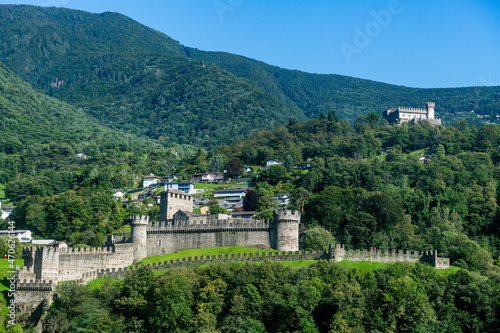 Switzerland, Ticino, Bellinzona, Montebello castle with green forested mountains in background photo