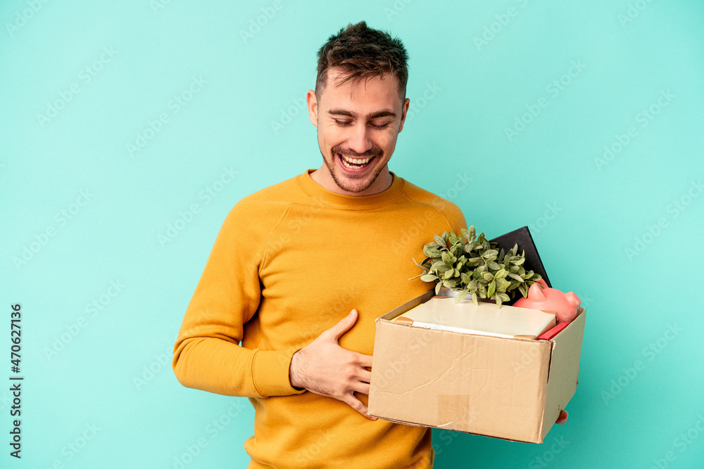 Young caucasian man making a move isolated on blue background laughing and having fun. Young caucasian man making a move isolated on blue background laughing and having fun.