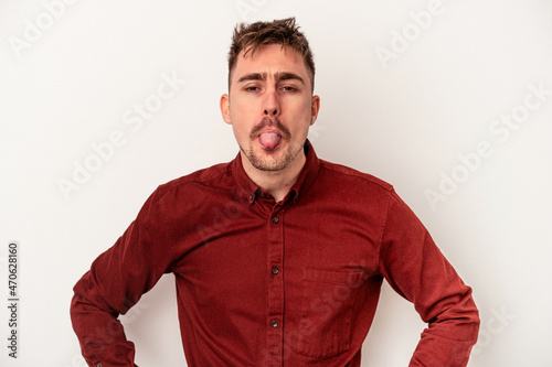 Young caucasian man isolated on white background impressed holding copy space on palm.