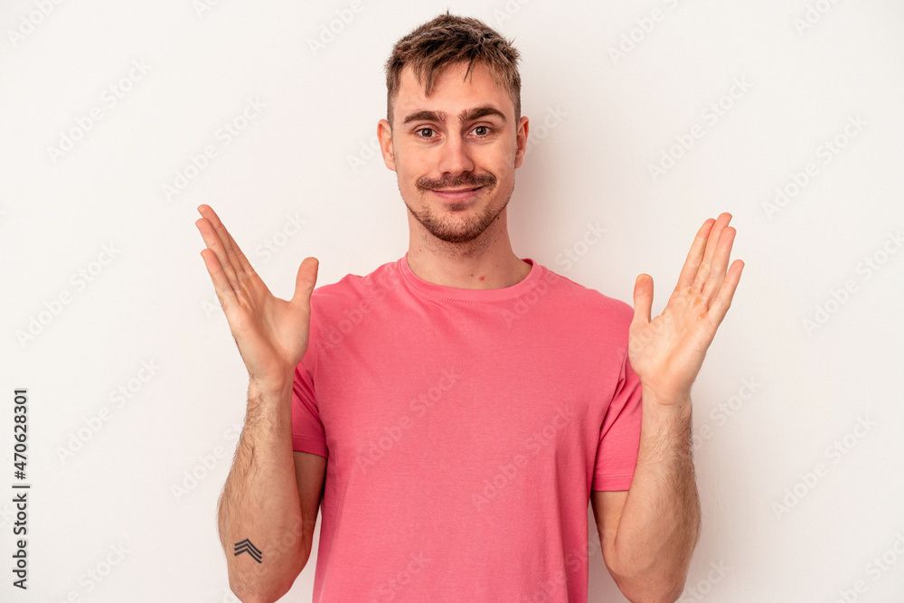 Young caucasian man isolated on white background laughing keeping hands on heart, concept of happiness. Young caucasian man isolated on white background laughing keeping hands on heart, concept of happiness.