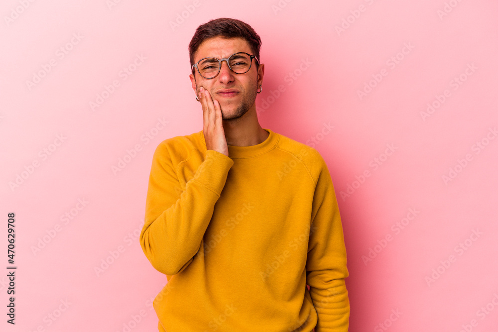 Young caucasian man with tattoos isolated on yellow background having a strong teeth pain, molar ache. Young caucasian man with tattoos isolated on yellow background having a strong teeth pain, molar ache.