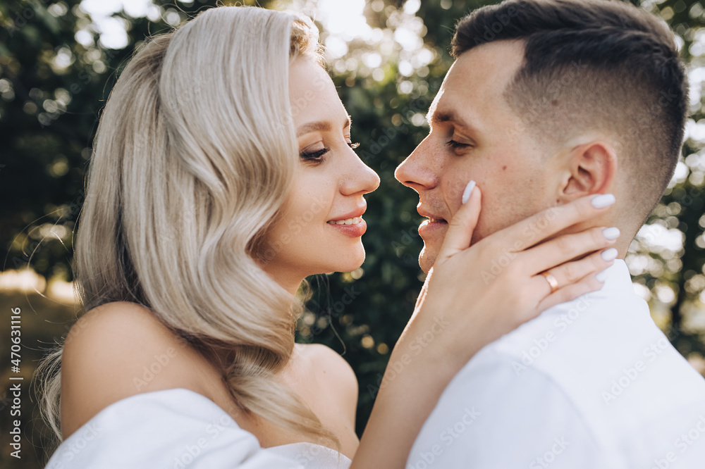 Fototapeta premium Wedding photo, close-up portrait of newlyweds faces profile in nature.