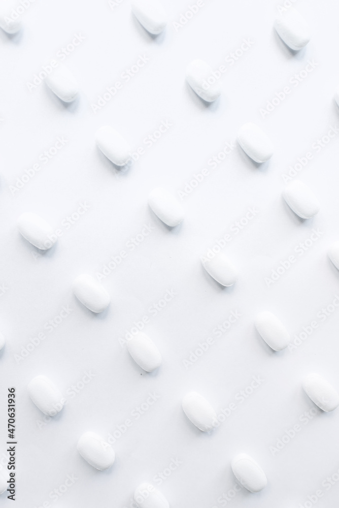 White pills on a white background. Oblong and round pills close-up. Healthcare and medicine.
White pills on a white background. Oblong and round pills close-up. Healthcare and medicine.