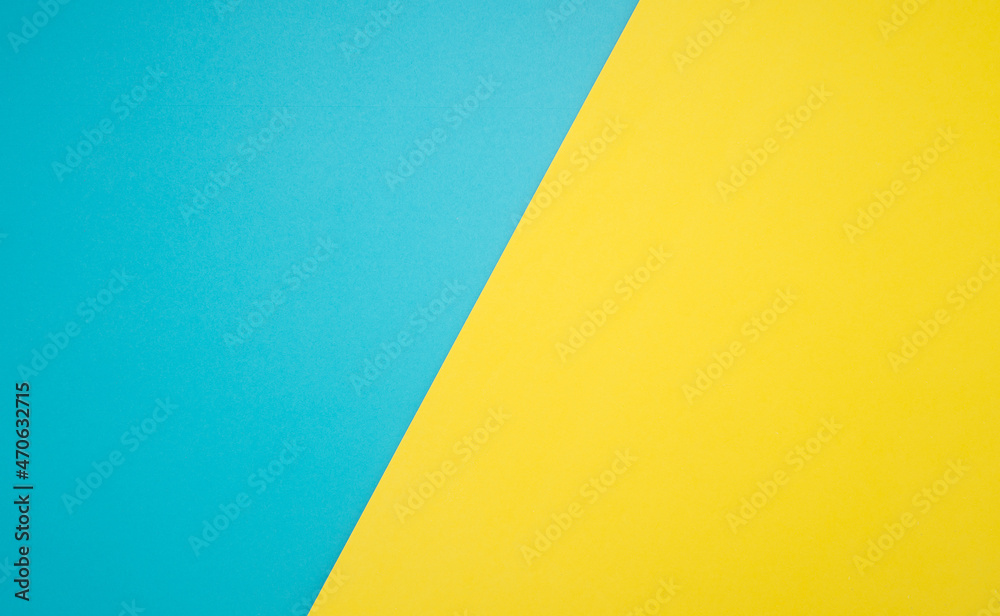 Top view of blue and yellow paper background with space for text