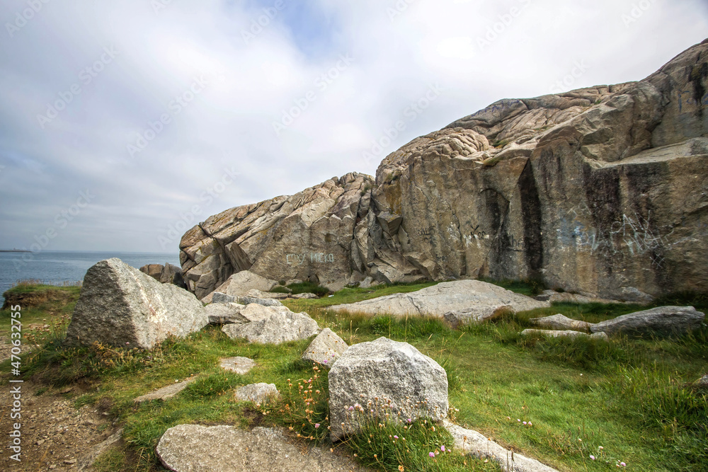 Dalkey cliffs and rocks seashore in sunny day, rocks on the seashore, Dublin county, Ireland