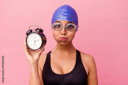 Quadro em tela A confident swimmer with cap and goggles holds a trusty alarm clock