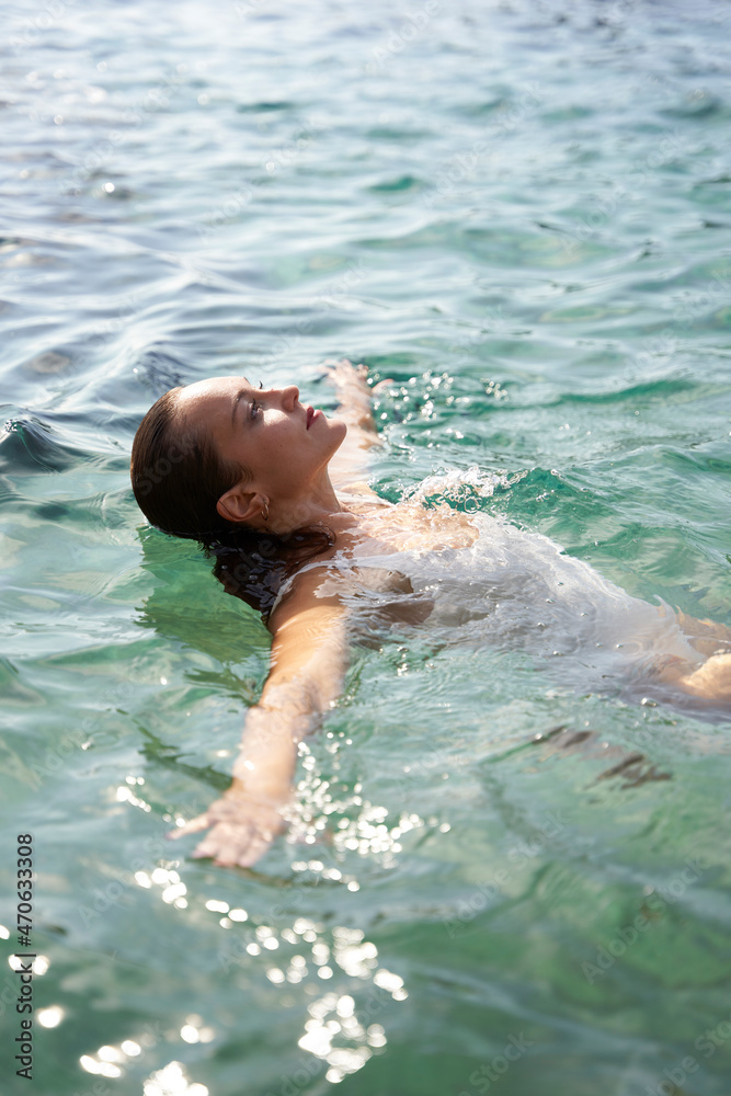Woman swimming in sea on weekend