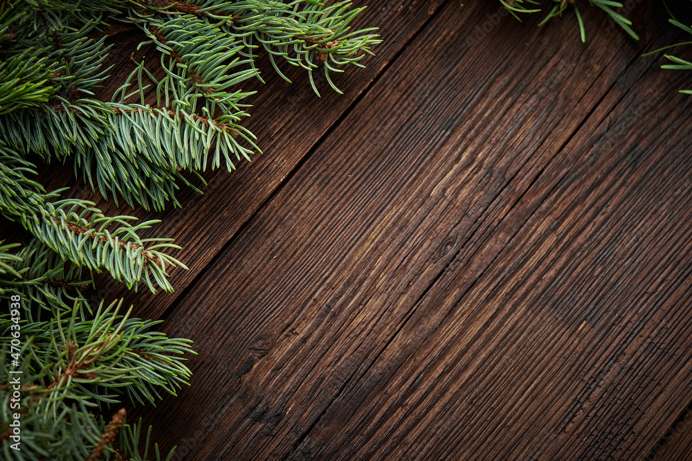 Creative layout made of winter evergreen tree branches over rustic wooden background. Flat lay. Nature Christmas concept. New Year concept. Creative layout made of winter evergreen tree branches over rustic wooden background. Flat lay. Nature Christmas concept. New Year concept.