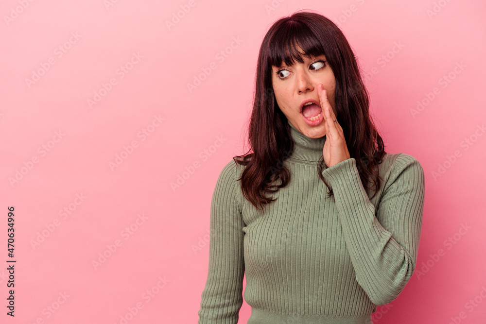 Young caucasian woman isolated on pink background is saying a secret hot braking news and looking aside Young caucasian woman isolated on pink background is saying a secret hot braking news and looking aside