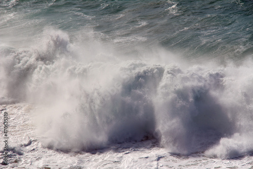 Ocean wave with water foam. A big wave in the Atlantic Ocean with a strong wind. 
