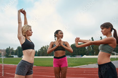 Fototapeta Naklejka Na Ścianę i Meble -  Young sports women stretching before run training