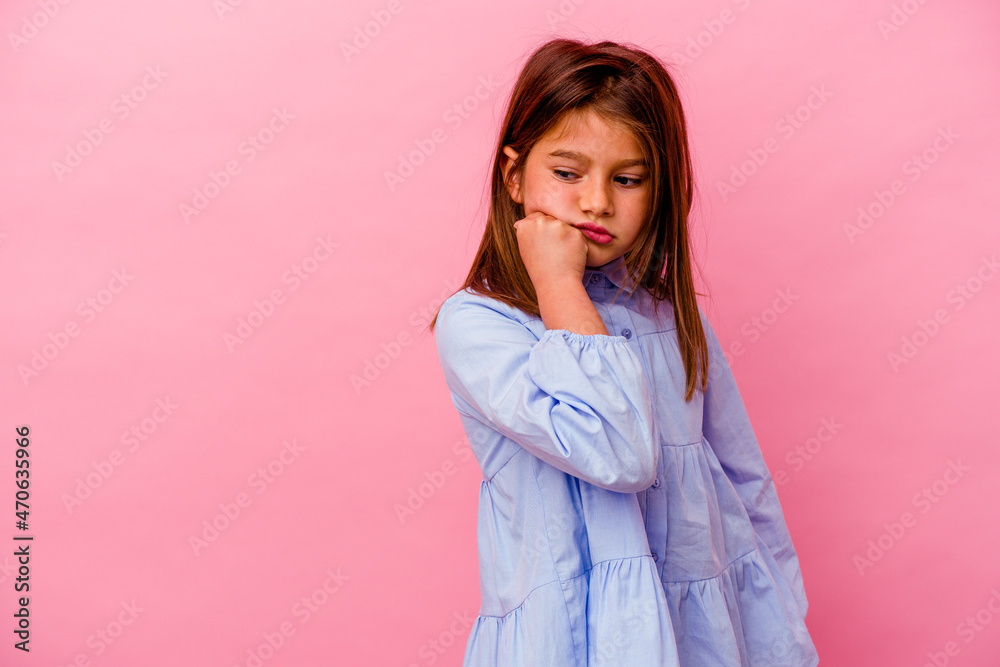 Little caucasian girl isolated on pink background who feels sad and pensive, looking at copy space. Little caucasian girl isolated on pink background who feels sad and pensive, looking at copy space.