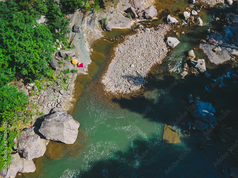 aerial view of people resting at mountain river beach